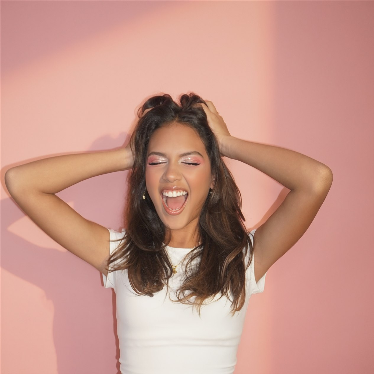 Naty G smiling against a pink background for the Love Language era.